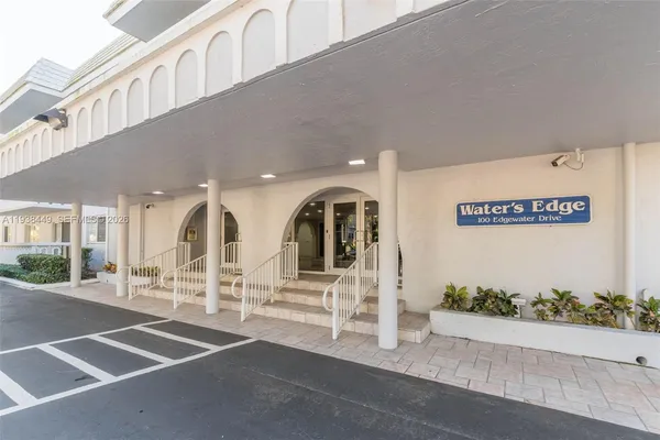 a view of a building with car parked