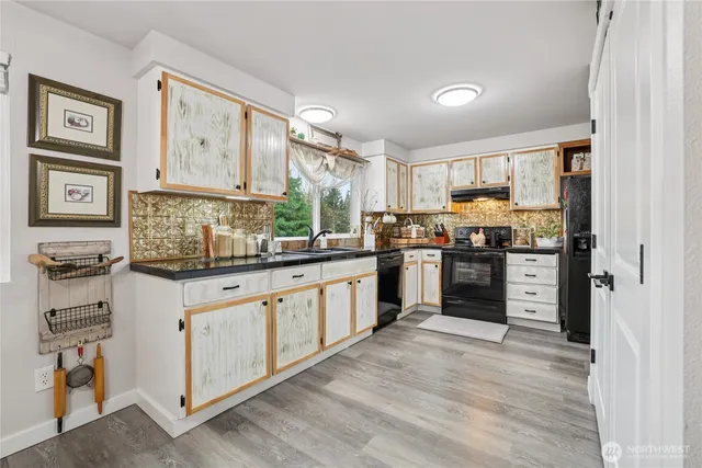 a kitchen with stainless steel appliances granite countertop a stove and a refrigerator