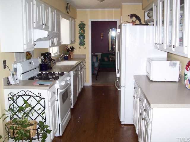 5612 Alpine Drive Raleigh, NC 27609 - Photo 3 of 10 a kitchen with stainless steel appliances a stove a sink a refrigerator and a refrigerator