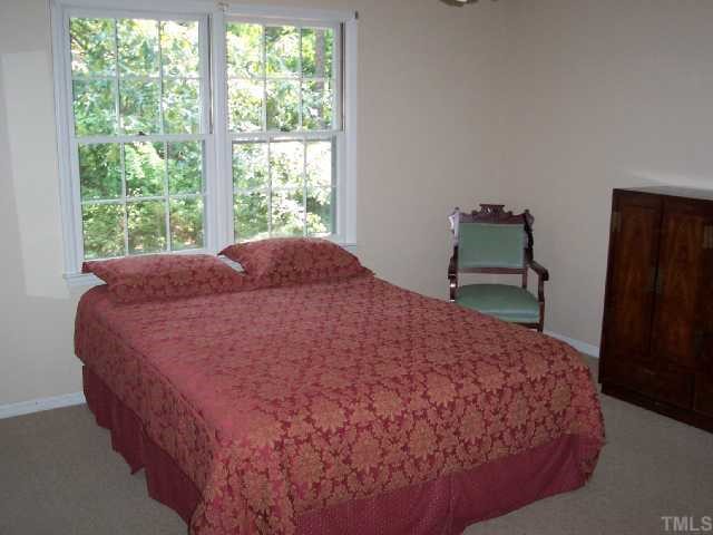 5612 Alpine Drive Raleigh, NC 27609 - Photo 8 of 10 a large bed sitting in a bedroom next to a window