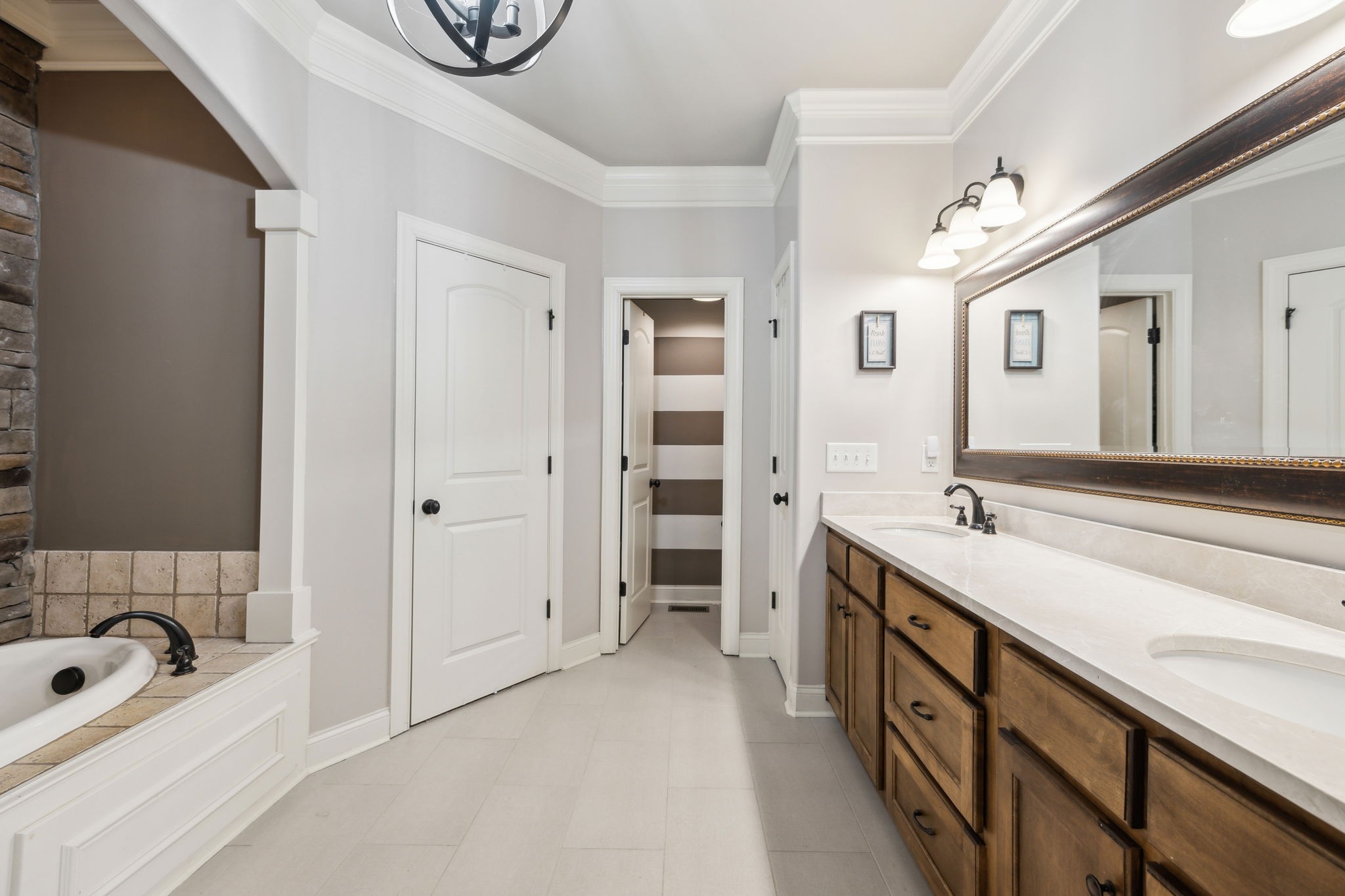 7023 Brindle Ridge Way Spring Hill, TN 37174 - Photo 12 of 26 a spacious bathroom with a double vanity sink a mirror and a bathtub