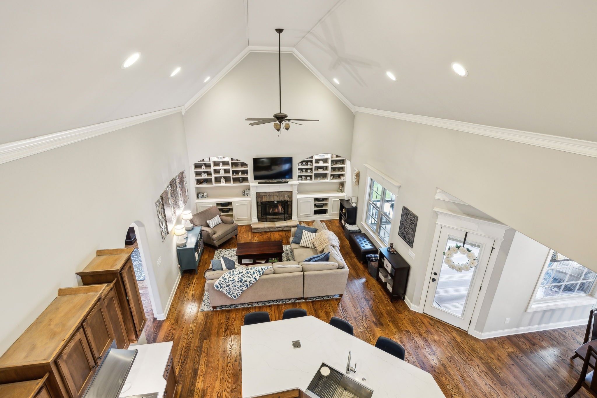 7023 Brindle Ridge Way Spring Hill, TN 37174 - Photo 17 of 26 a view of a livingroom with furniture a fireplace wooden floor and staircase