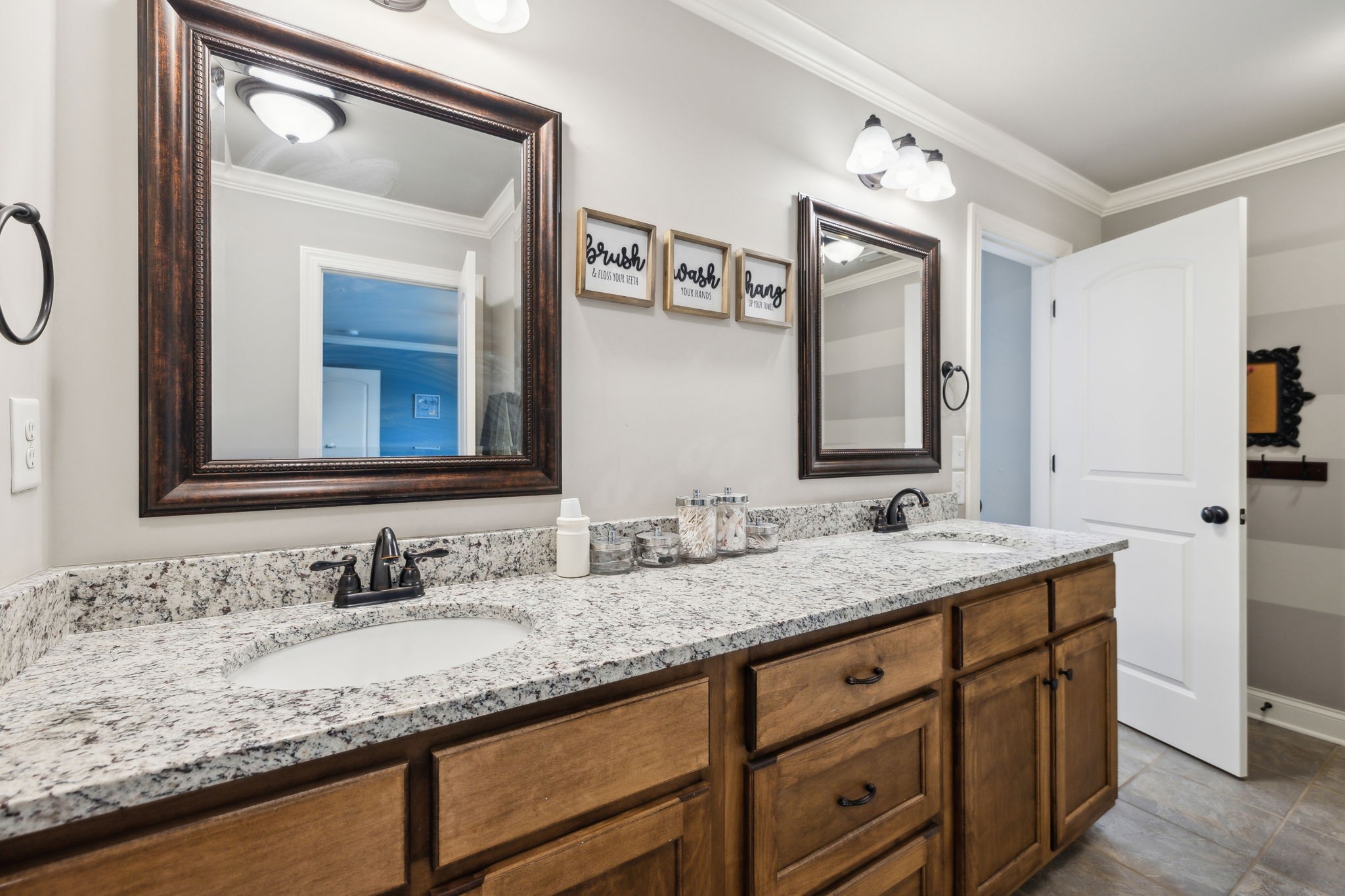 7023 Brindle Ridge Way Spring Hill, TN 37174 - Photo 20 of 26 a bathroom with a granite countertop sink vanity and a mirror