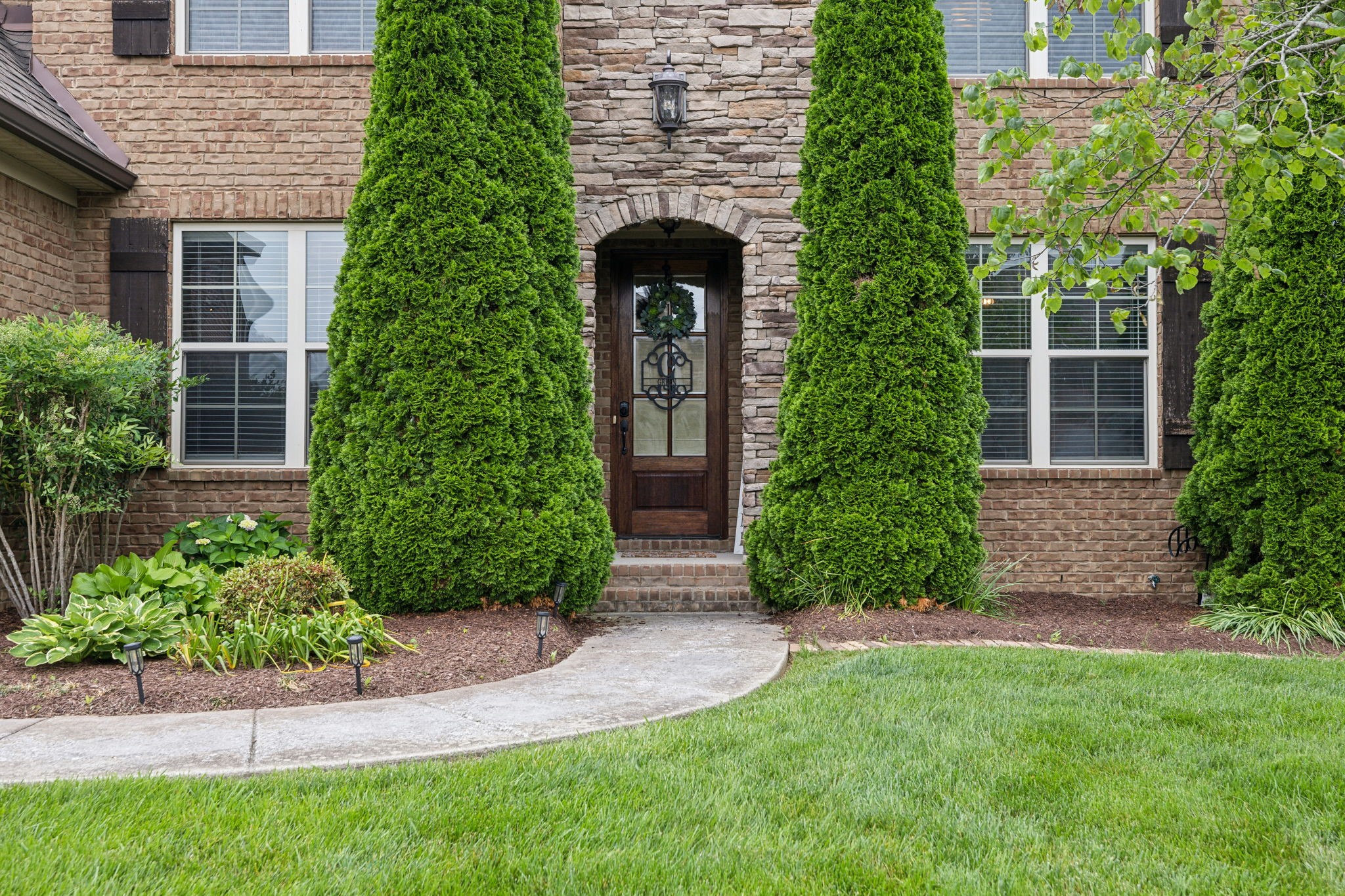 7023 Brindle Ridge Way Spring Hill, TN 37174 - Photo 2 of 26 front view of a house with a garden