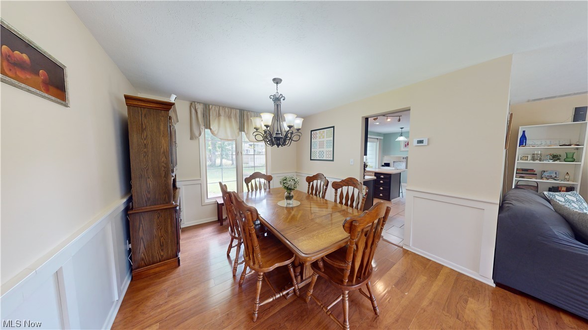 1071 Roland Road Lyndhurst, OH 44124 - Photo 5 of 30 Wood floored dining space featuring a notable chandelier