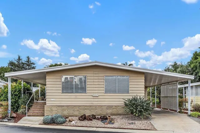 a view of a house with a backyard and garden