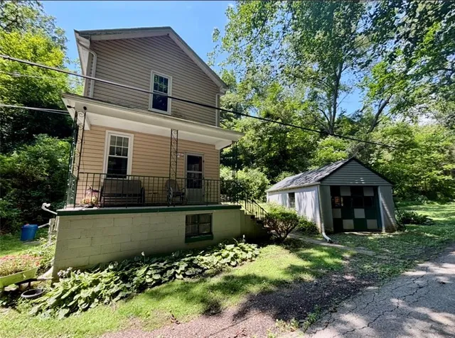 a front view of a house with a garden