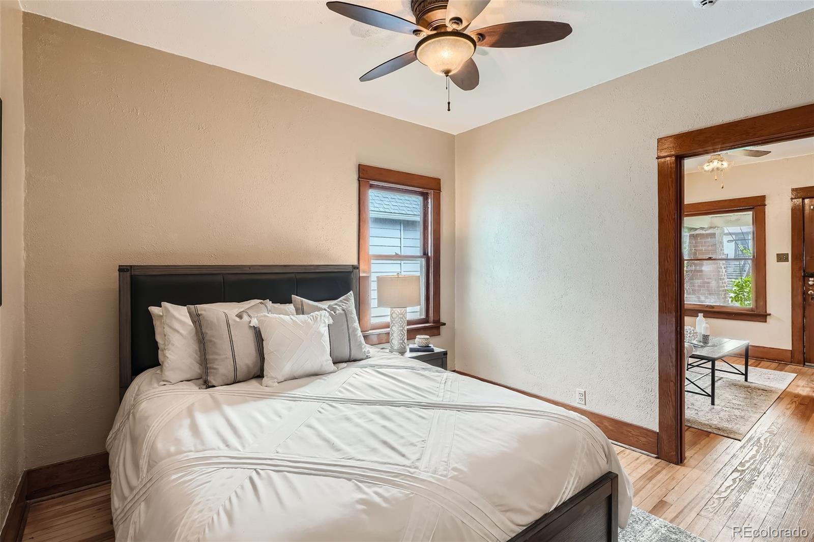 827 South Sherman Street Denver, CO 80209 - Photo 11 of 27 a bedroom with a bed and wooden floor