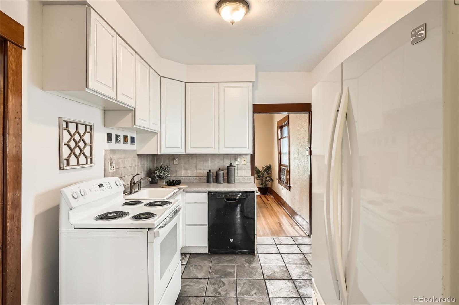 827 South Sherman Street Denver, CO 80209 - Photo 17 of 27 a kitchen with a sink a stove and refrigerator