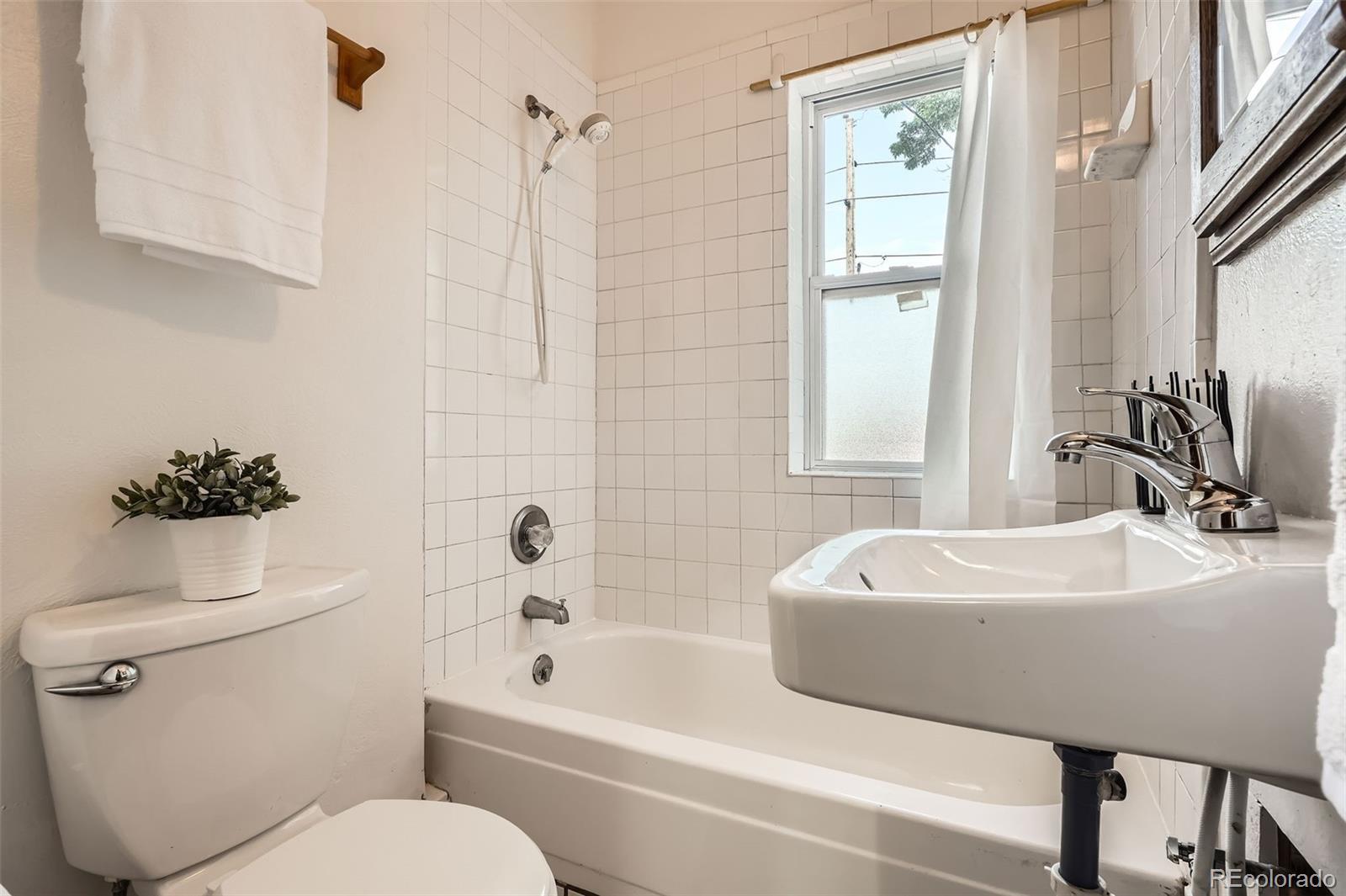 827 South Sherman Street Denver, CO 80209 - Photo 18 of 27 a bathroom with a sink toilet and shower