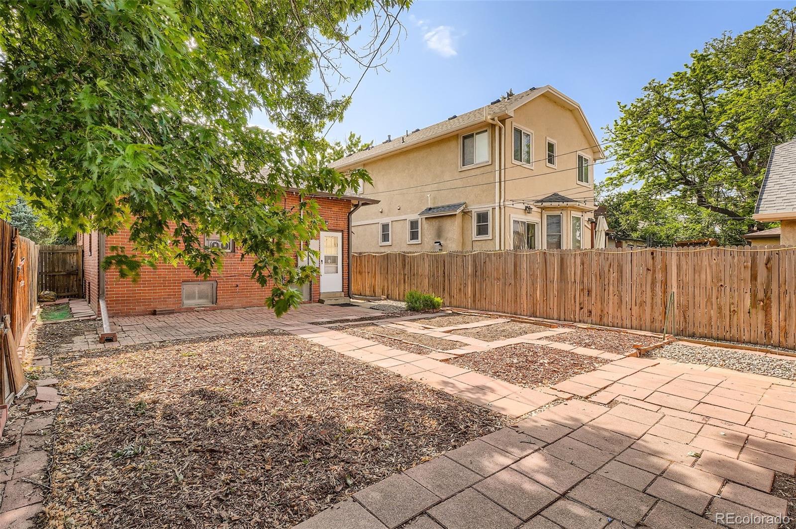 827 South Sherman Street Denver, CO 80209 - Photo 26 of 27 a front view of a house with a yard and garage