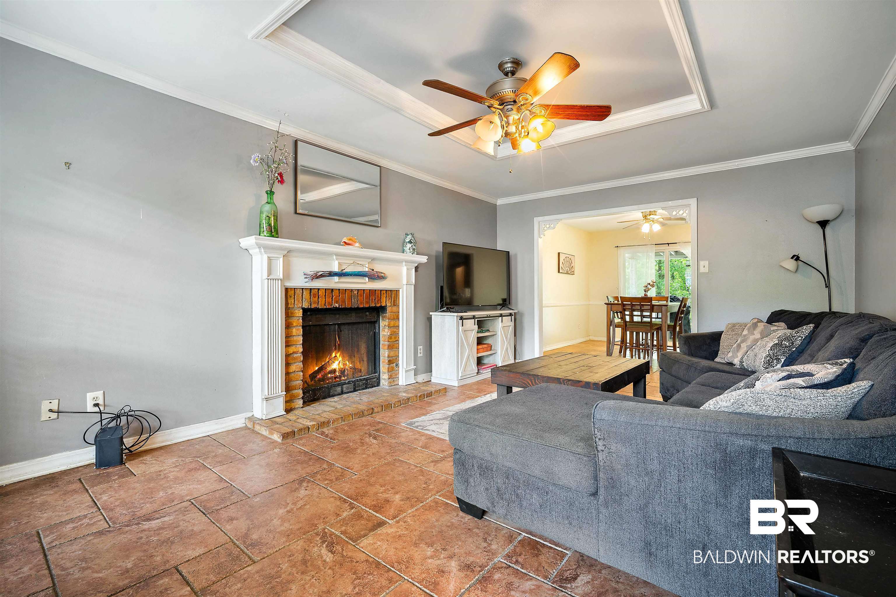 2823 Woodland Road Mobile, AL 36693 - Photo 2 of 29 Living room with ceiling fan, crown molding, and a brick fireplace