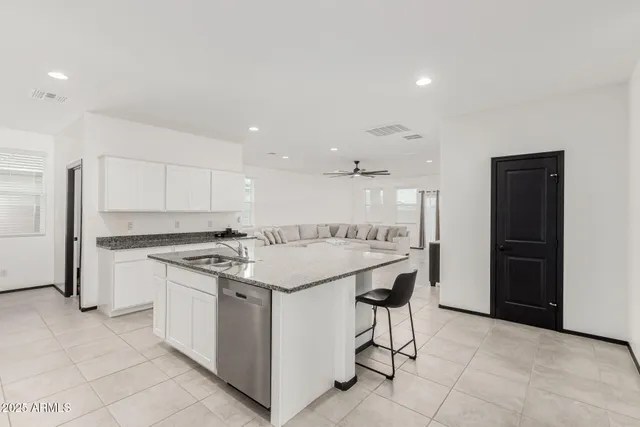 a large kitchen with a stove a refrigerator and a sink