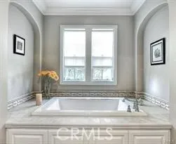 a bathroom with mirror sink and window