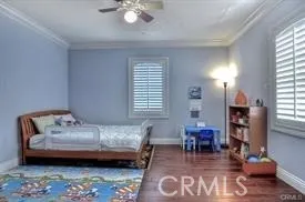 a bedroom with furniture and a wooden floor
