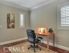 a view of a workspace with furniture and a window