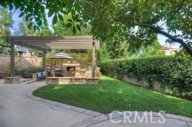 22 Sanctuary Irvine, CA 92620 - Photo 19 of 45 a view of a patio with table and chairs potted plants and large tree