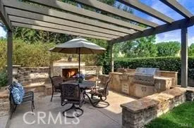 a view of a patio with table and chairs under an umbrella