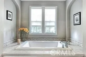 a bathroom with bathtub and window