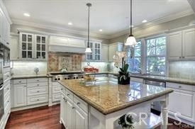 22 Sanctuary Irvine, CA 92620 - Photo 9 of 45 a kitchen with stainless steel appliances granite countertop a sink a stove and a wooden floor