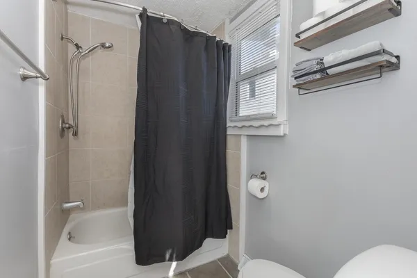 a bathroom with a toilet and a shower