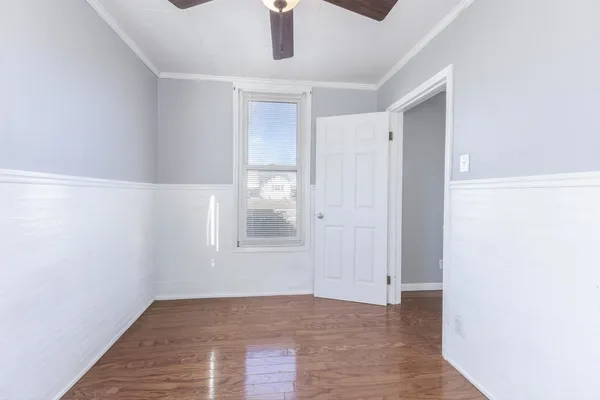 an empty room with windows and closet