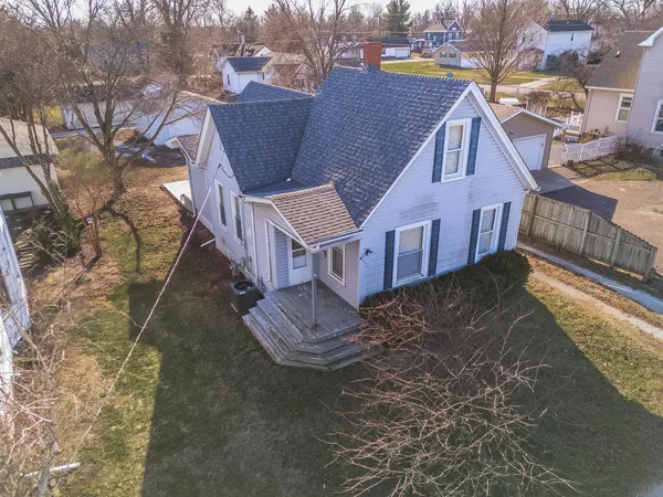 a view of a house with wooden fence