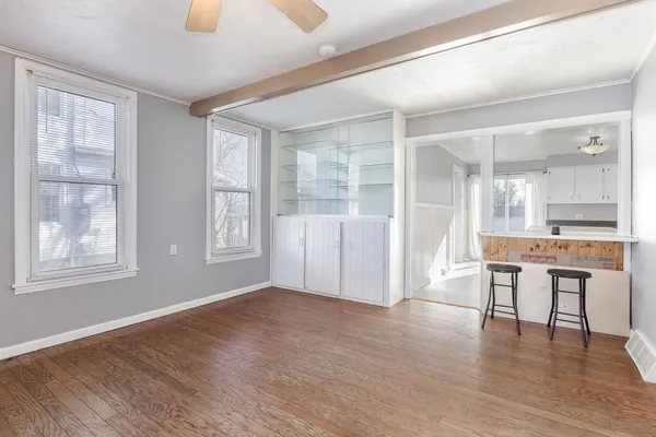 a view of a livingroom with furniture wooden floor and windows