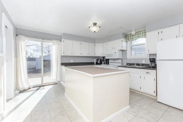 a kitchen with a refrigerator a sink and cabinets