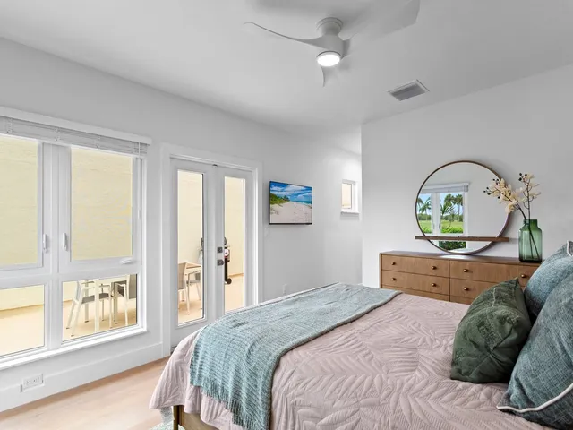 a bedroom with a bed window and table