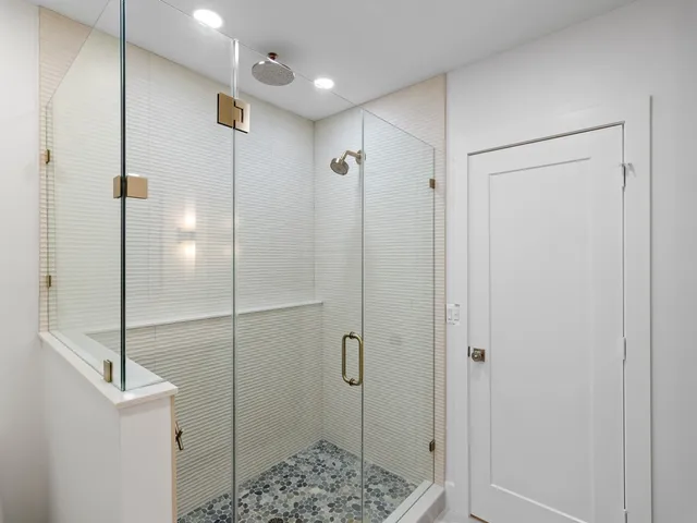 a bathroom with a shower and a sink
