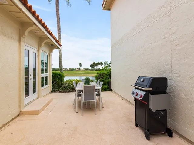 a dining room with furniture and a floor to ceiling window