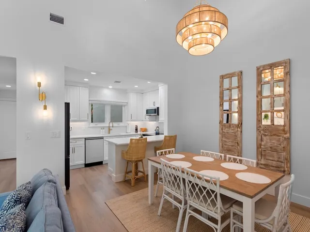 a view of a dining room with furniture and chandelier