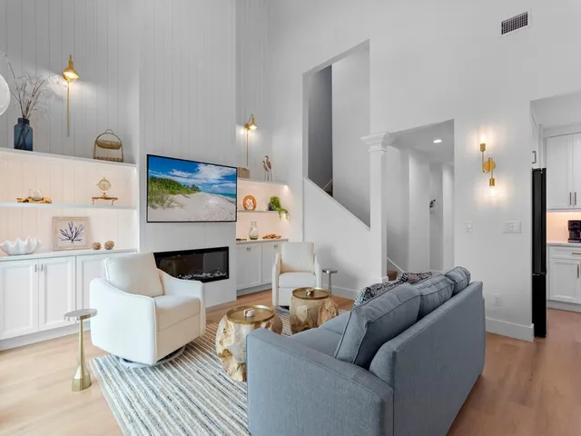 a living room with furniture and a lamp