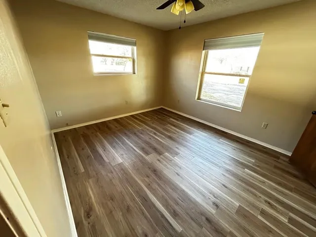 a view of an empty room and wooden floor