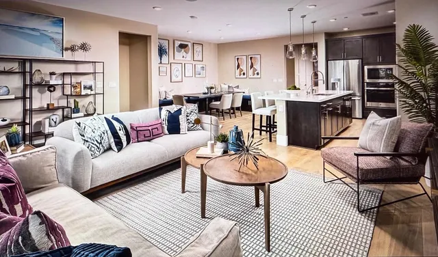 a living room with furniture a rug and a bookshelf