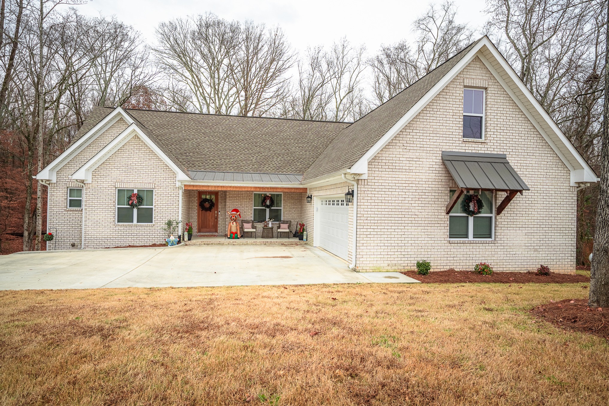 54 Spring Drive Killen, AL 35645 - Photo 3 of 75 front view of a house with a yard covered in snow