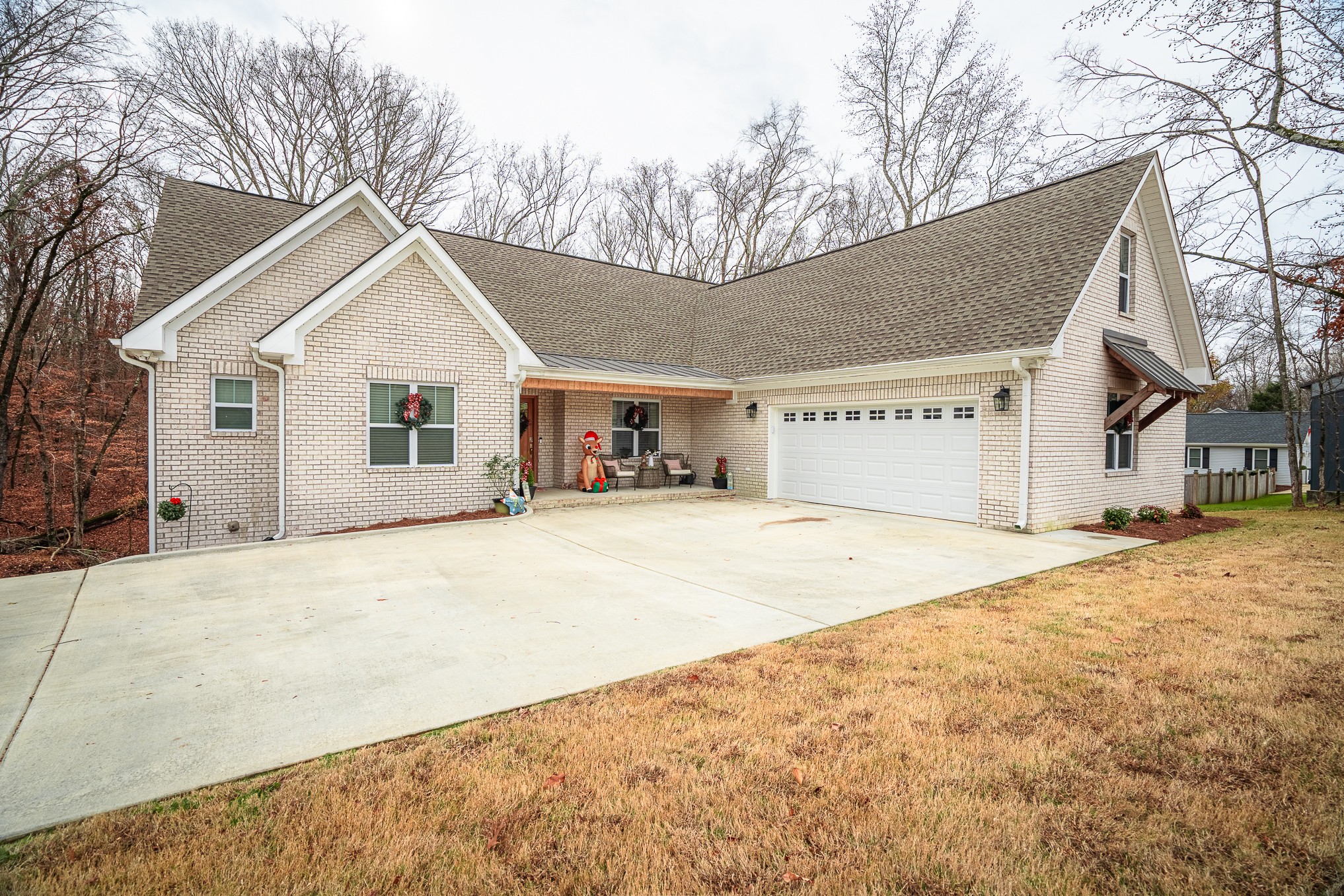 54 Spring Drive Killen, AL 35645 - Photo 5 of 75 a front view of a house with a yard and garage