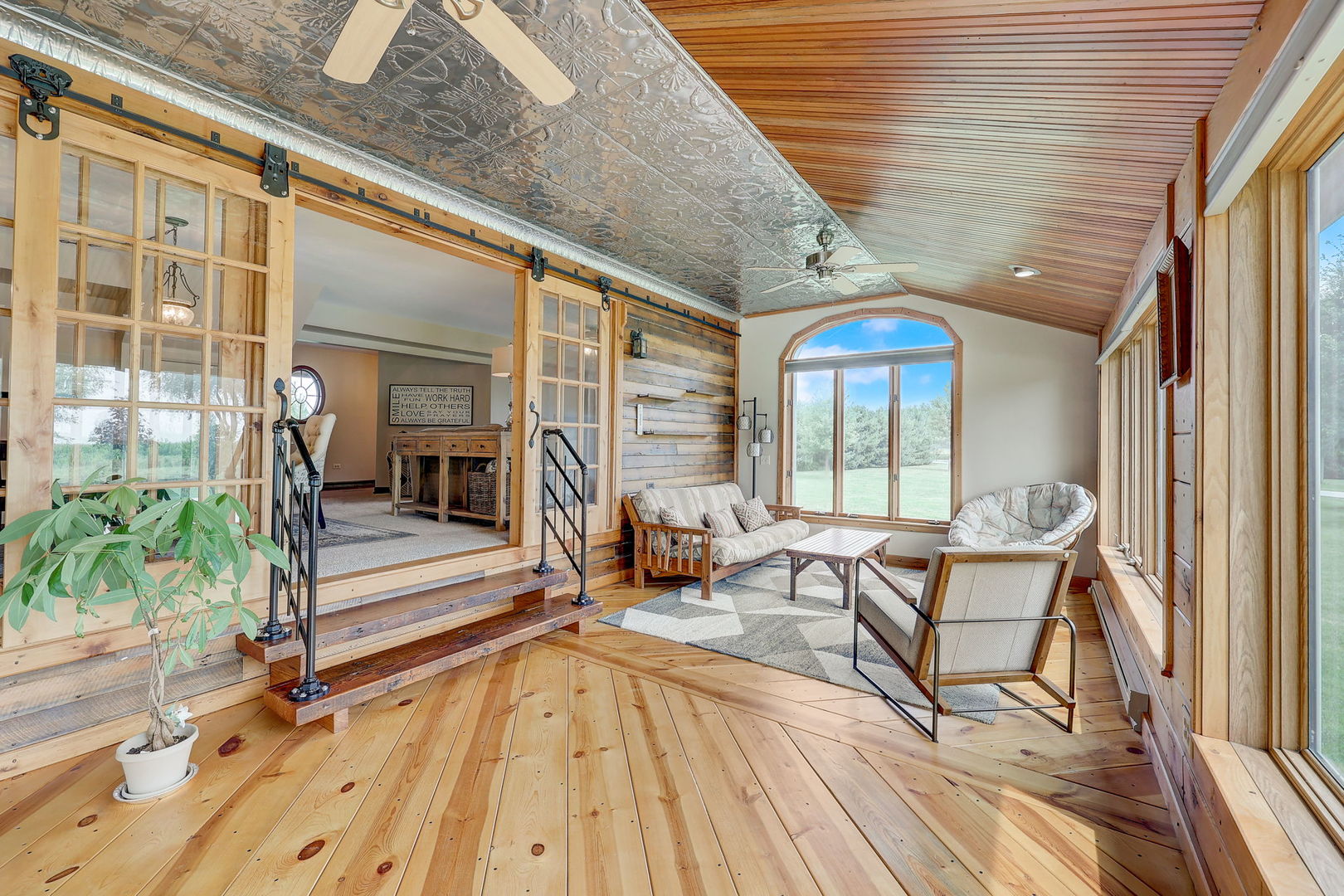 4234 East 12000th Road North Peotone, IL 60468 - Photo 18 of 62 a view of a balcony with chairs and wooden floor