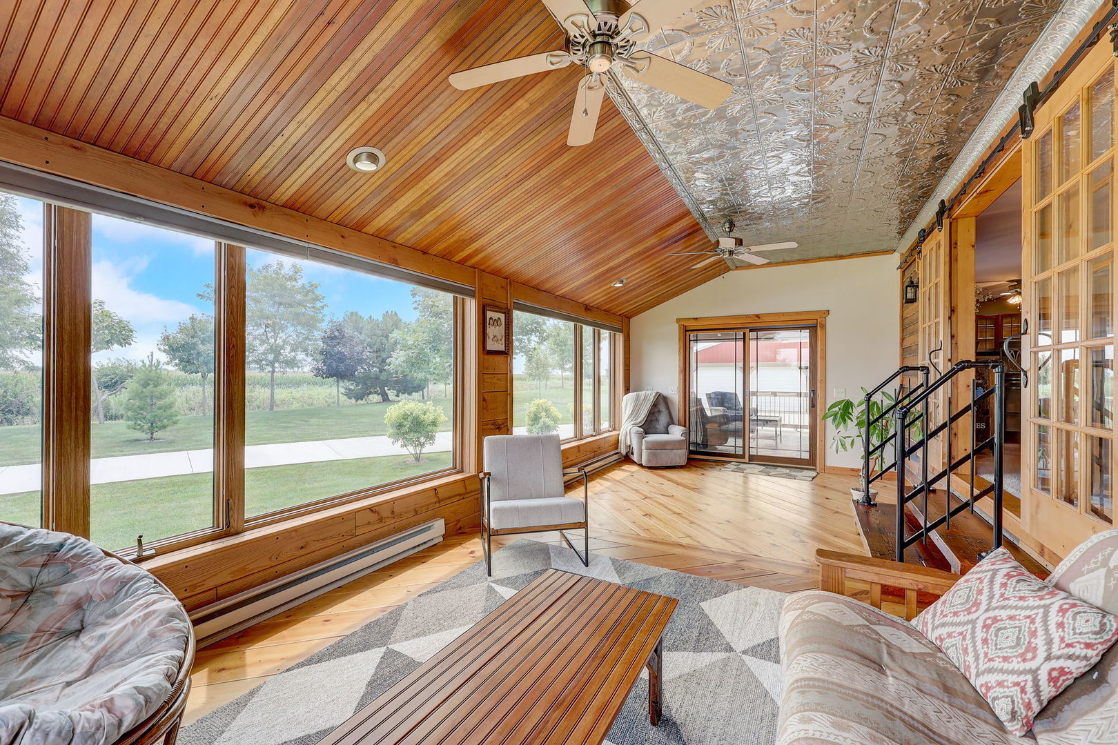 4234 East 12000th Road North Peotone, IL 60468 - Photo 20 of 62 a living room with furniture floor to ceiling windows and wooden floor