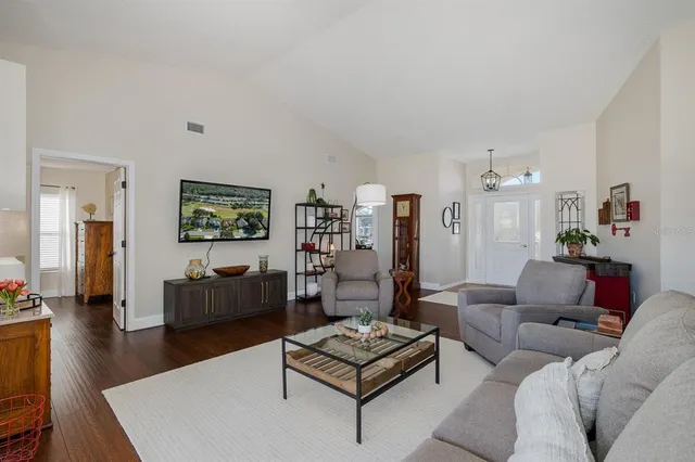 a living room with furniture a rug and a chandelier