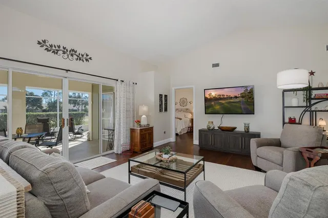 a kitchen with stainless steel appliances granite countertop a stove top oven a sink and a refrigerator