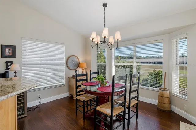 a bathroom with a granite countertop toilet a sink and a mirror