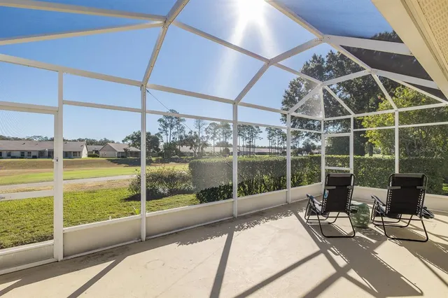 a view of a swimming pool with outdoor seating and plants