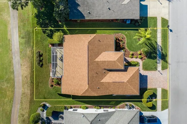 an aerial view of residential houses with outdoor space and trees