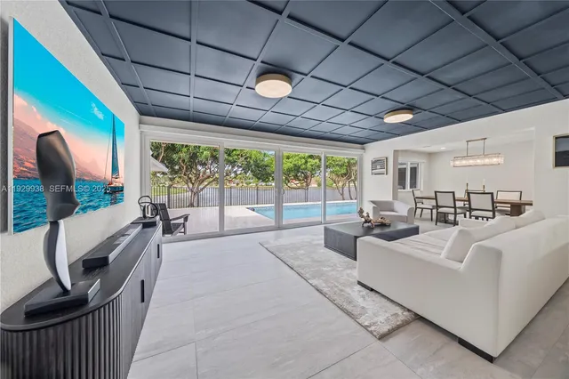 a living room with furniture and a floor to ceiling window