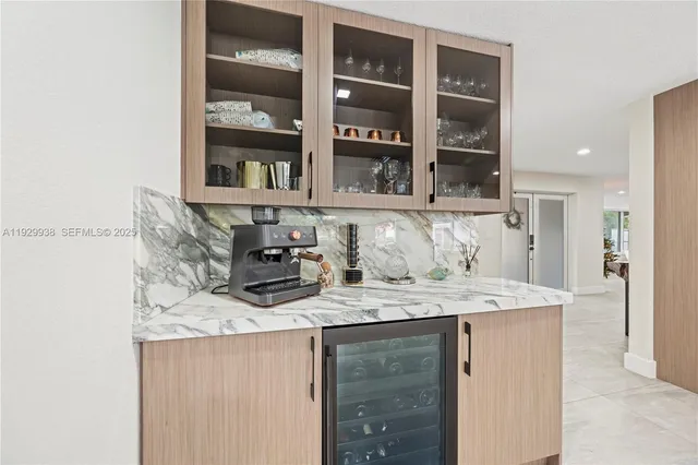 a kitchen with stainless steel appliances granite countertop a kitchen island a stove a refrigerator and a sink