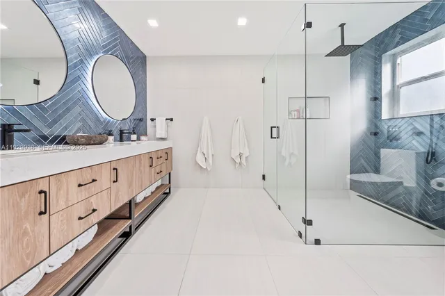 a bathroom with a double vanity sink and a mirror