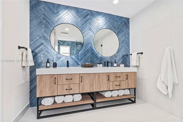 a spacious bathroom with a mirror a sink and a mirror