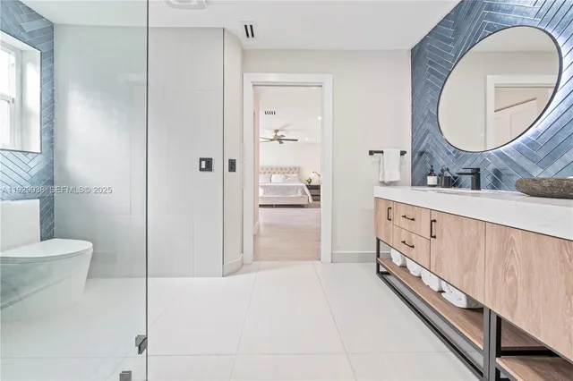 a spacious bedroom with a bed and a chandelier